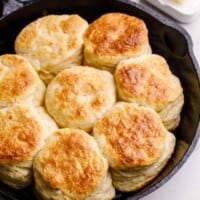 A skillet full of baked buttermilk biscuits.