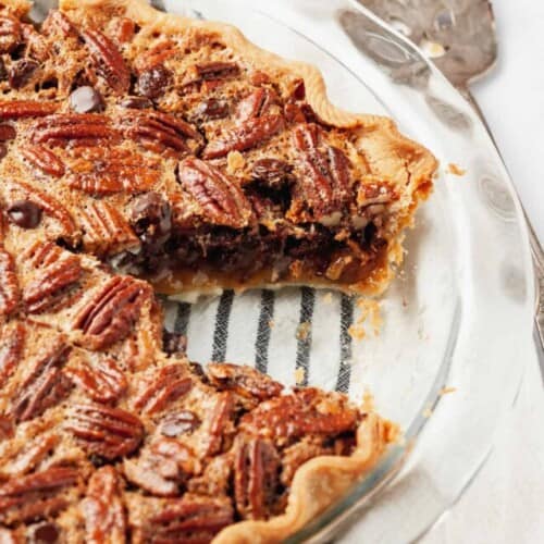Chocolate pecan pie with a slice missing.