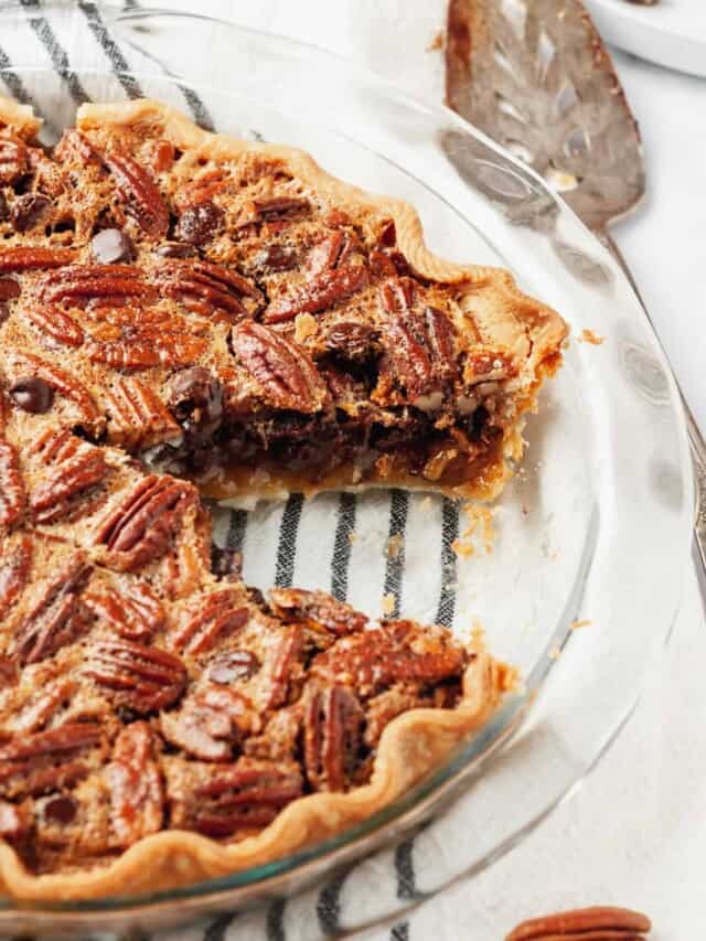 Chocolate pecan pie with a slice missing.