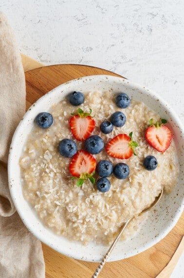 A bowl of Instant Pot oatmeal topped with blueberries and strawberries.