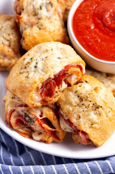 Pepperoni rollups on a plate.