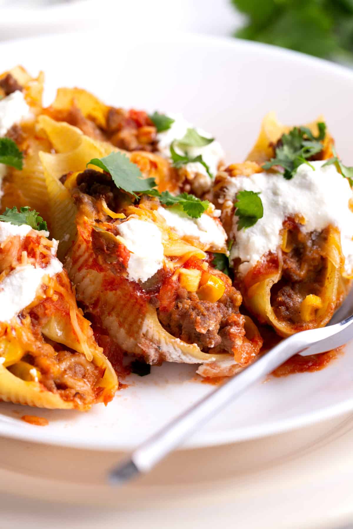 A plate full of taco stuffed shells.