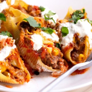 A plate full of taco stuffed shells.