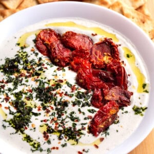 A bowl of whipped feta dip with pita chips.