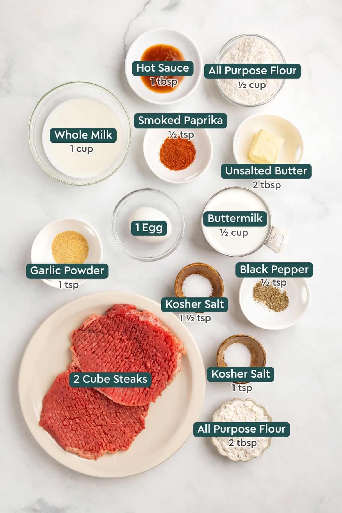 All of the ingredients for air fryer chicken fried steak in bowls on a white countertop.