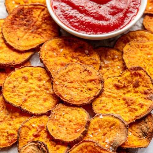 Air fryer sweet potato chips with a side of barbecue sauce.