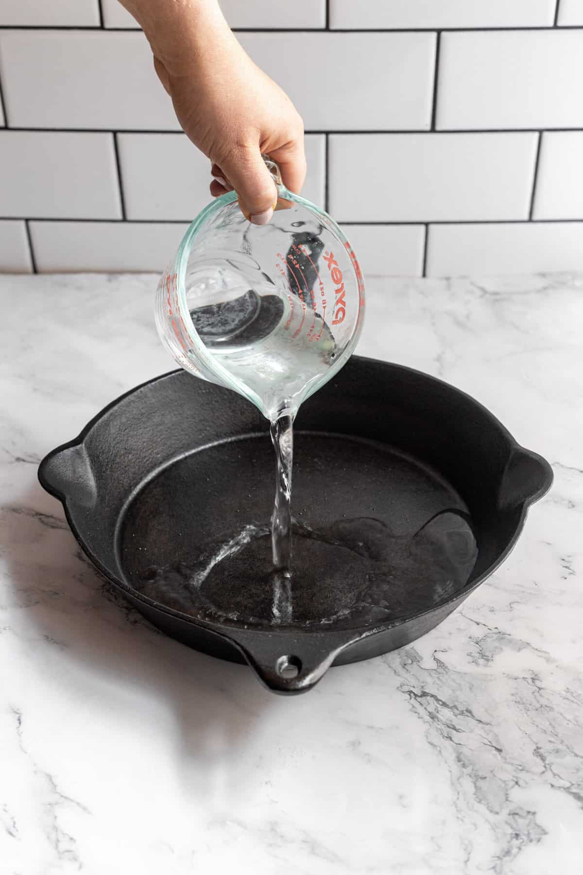 Clean cast iron pans with hot water—and maybe a little soap.