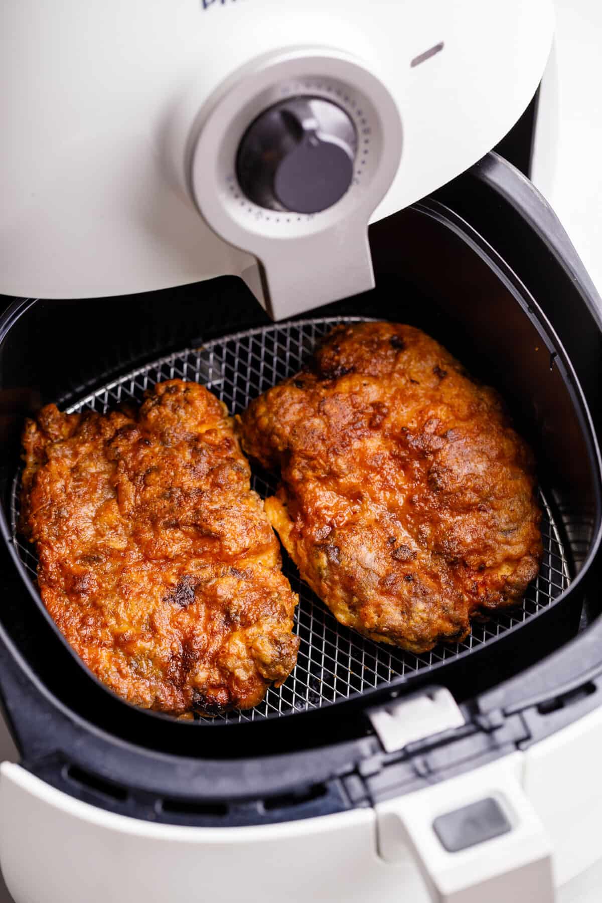 chicken-fried steak sitting in an air fryer.