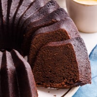 A chocolate pound cake with a slice missing.