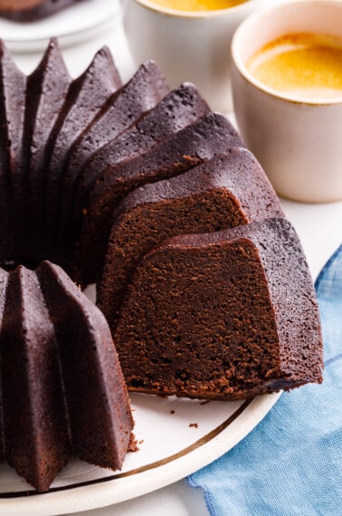 A chocolate pound cake with a slice missing.