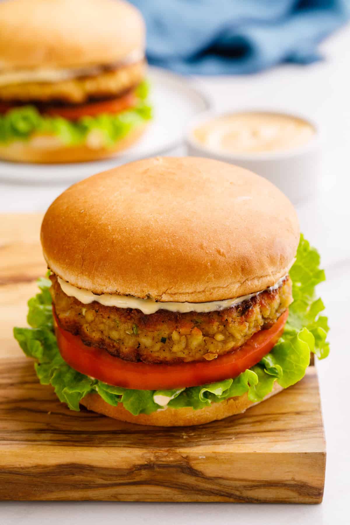 one serving of crab cake sandwich sitting on a wooden board