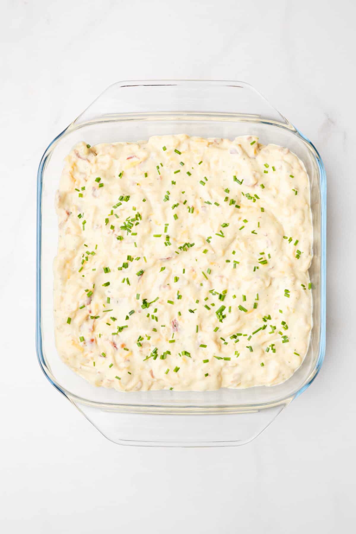 Step 4 to make pierogi casserole, top with more of the sauce you made on top of the layer of pierogies.