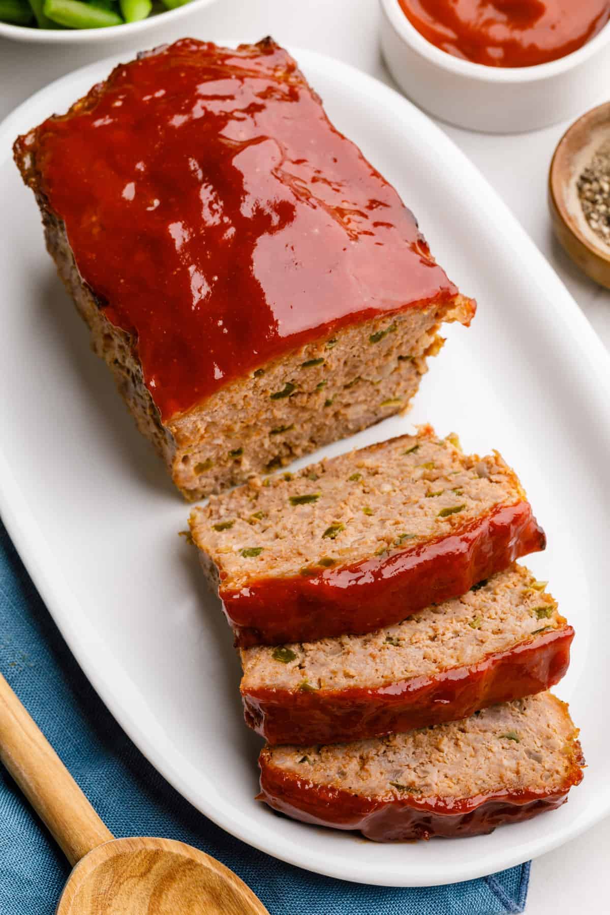 oval plate of southern meatloaf with three sliced servings