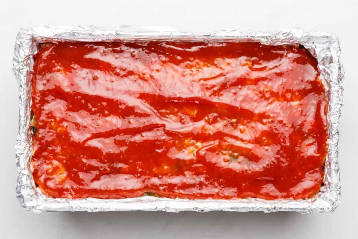 Cracker Barrel meatloaf covered in a sweet tomato glaze, freshly baked and still in the pan