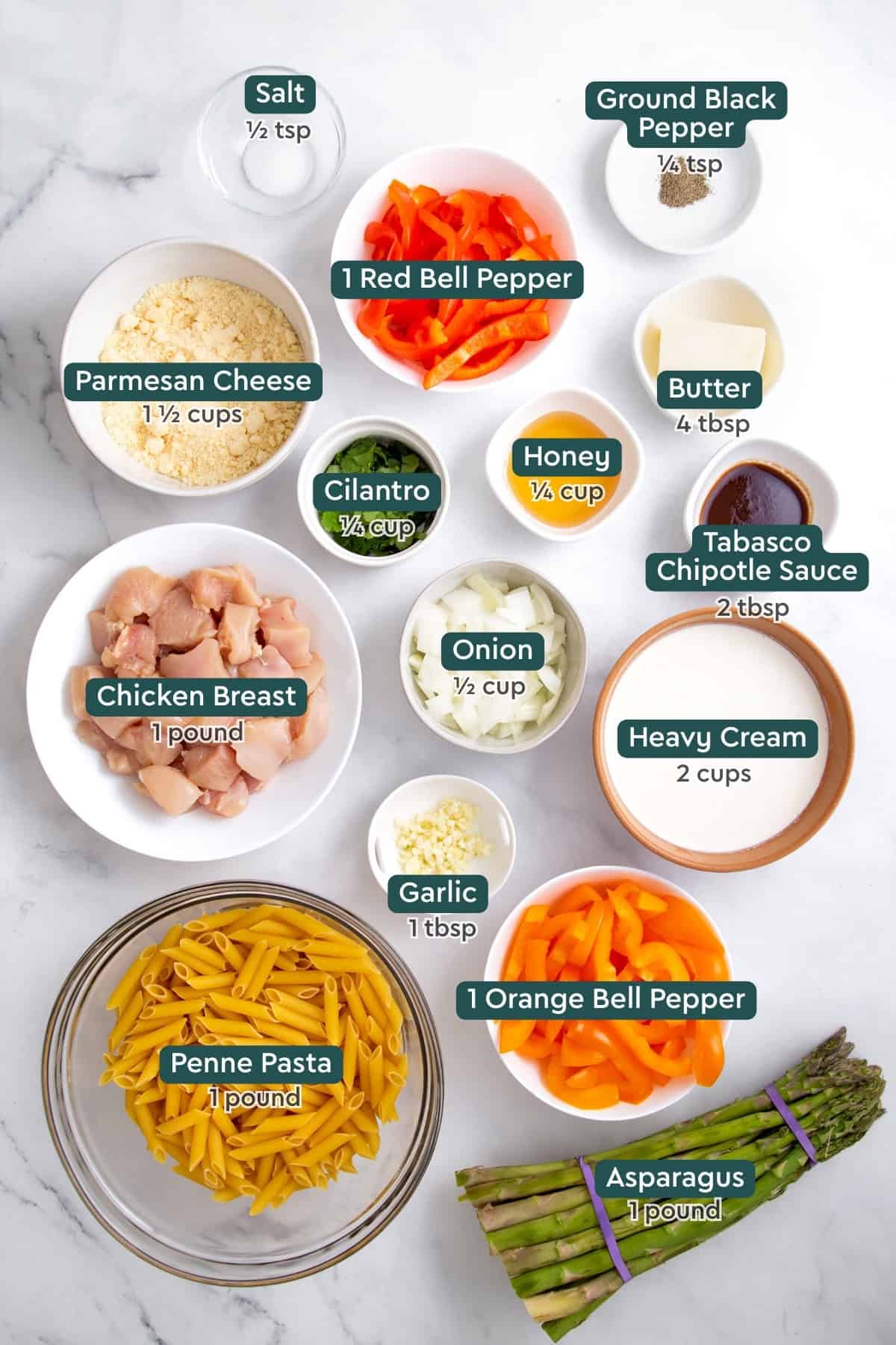 Ingredients for spicy chipotle chicken pasta, including salt, pepper, red bell pepper, parmesan, cilantro, honey, butter, tabasco, onion, chicken, cream, garlic, bell pepper, asparagus, and penne.