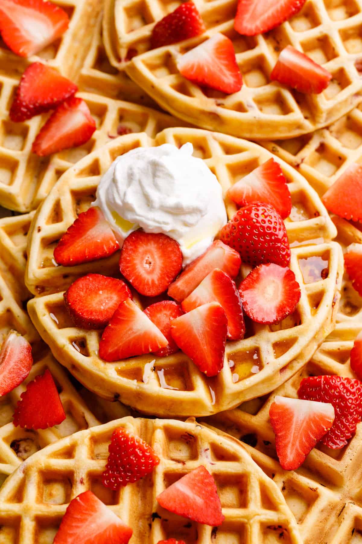 close up image of a pile of strawberry waffles