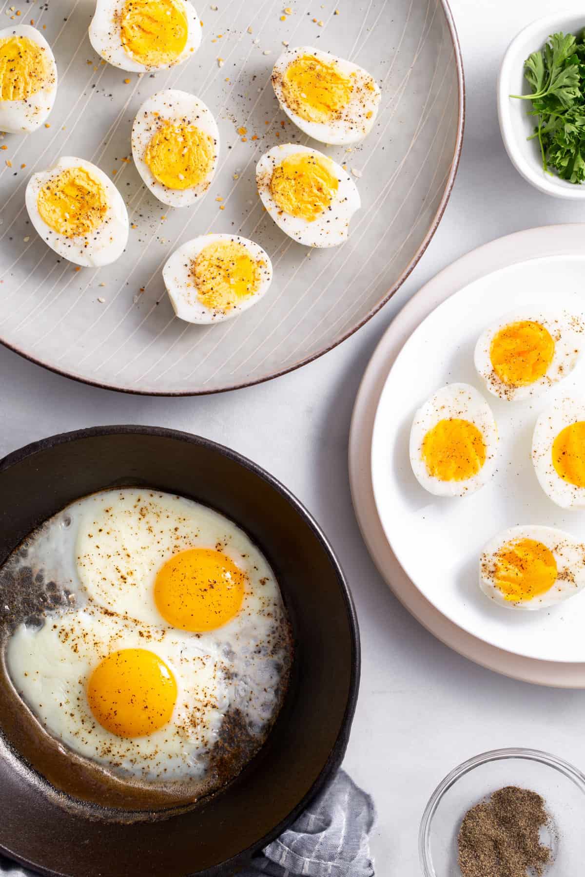 top down image of air fryer eggs 3 ways, hard boiled, soft boiled and fried eggs