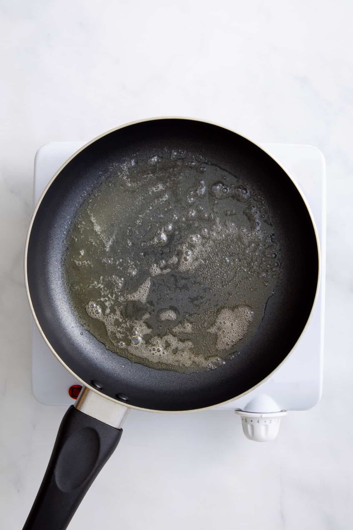 step 1 to make basted eggs, melt butter in the pan over medium-high heat.