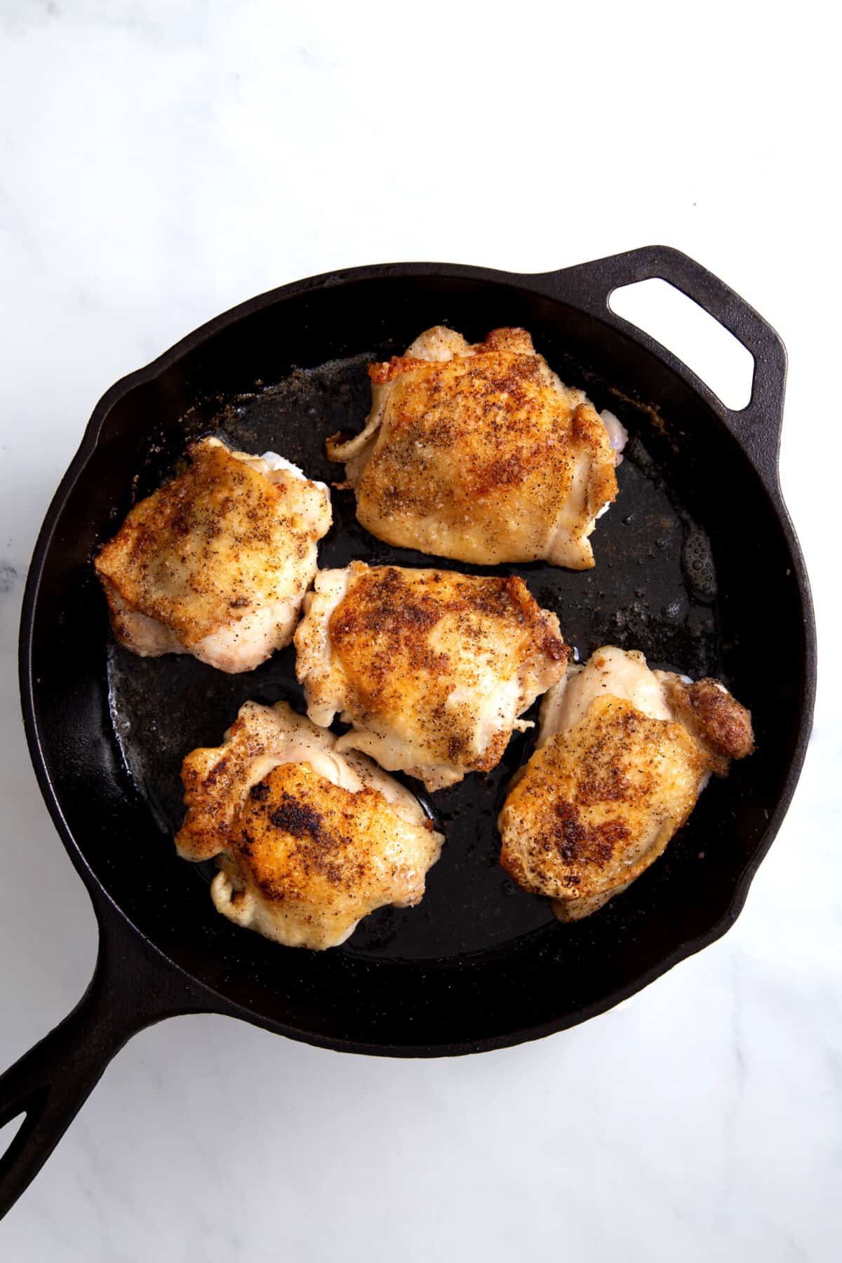 step 2 to make cast iron chicken thighs, cook chicken thighs on a hot cast iron skillet pan.