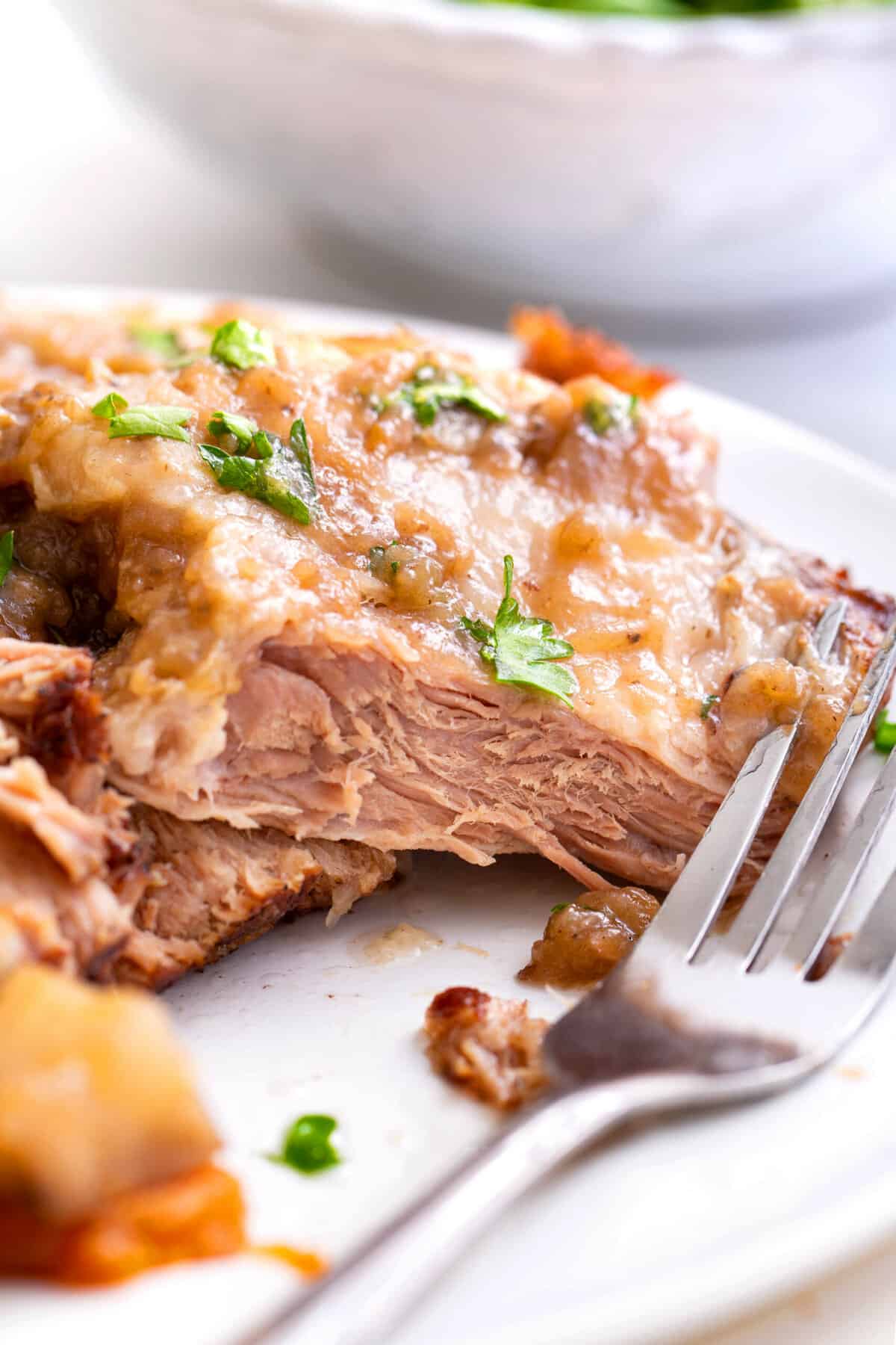 close up image of instant pot pork roast cross section served on a white round plate