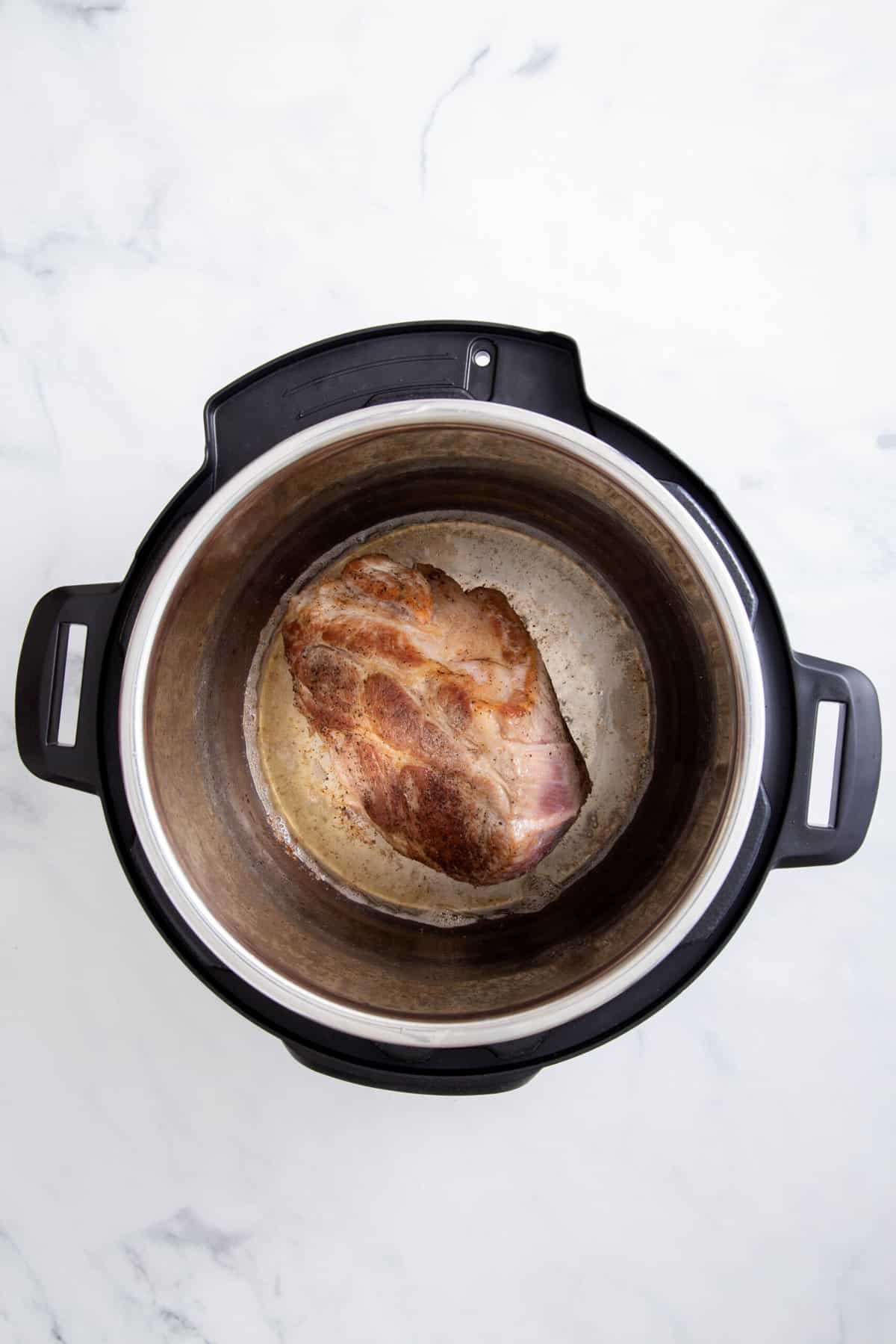 step 1 to make instant pot pork roast, sear the pork in the instant pot