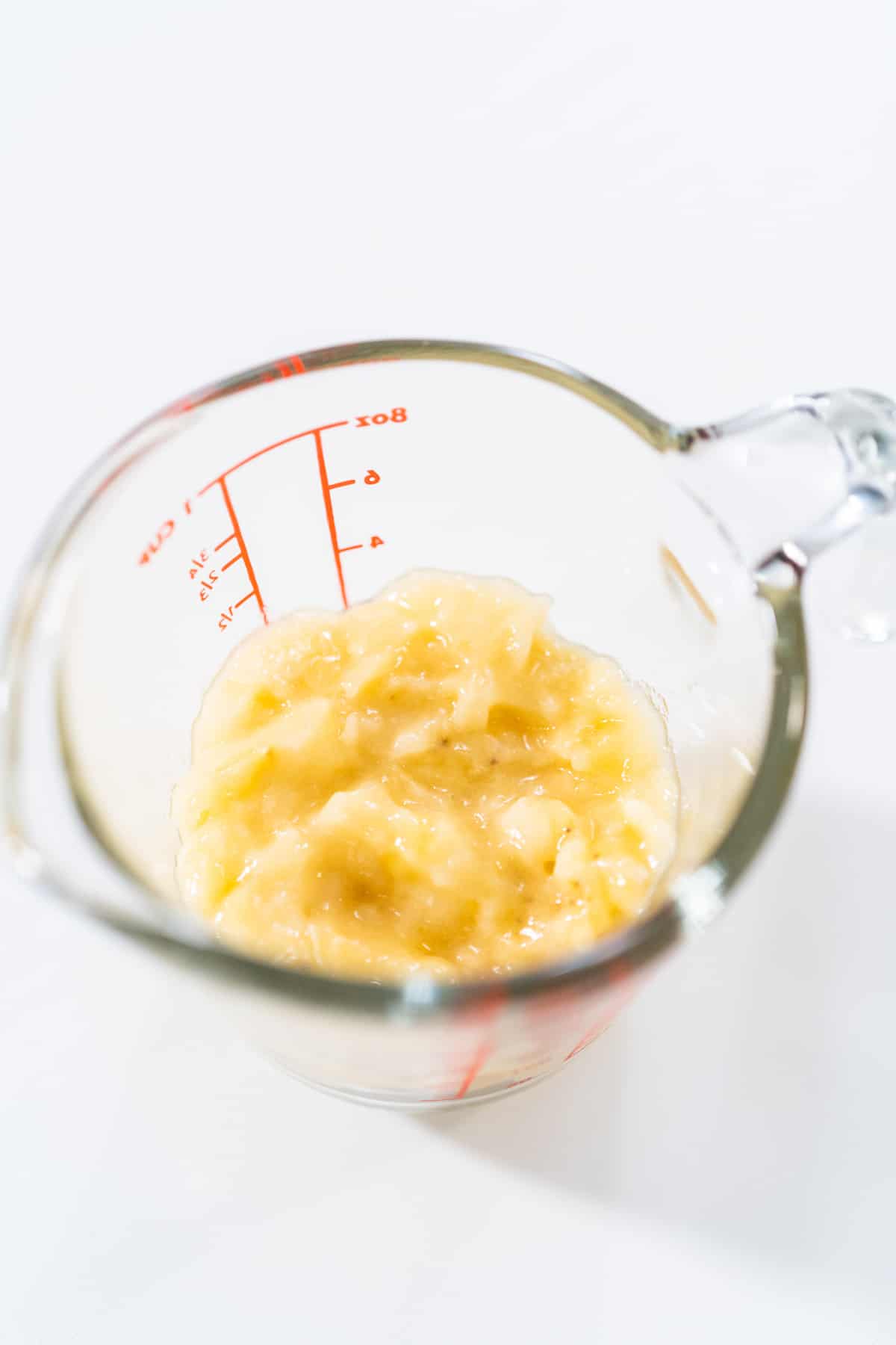 Mashed bananas in liquid measuring cup