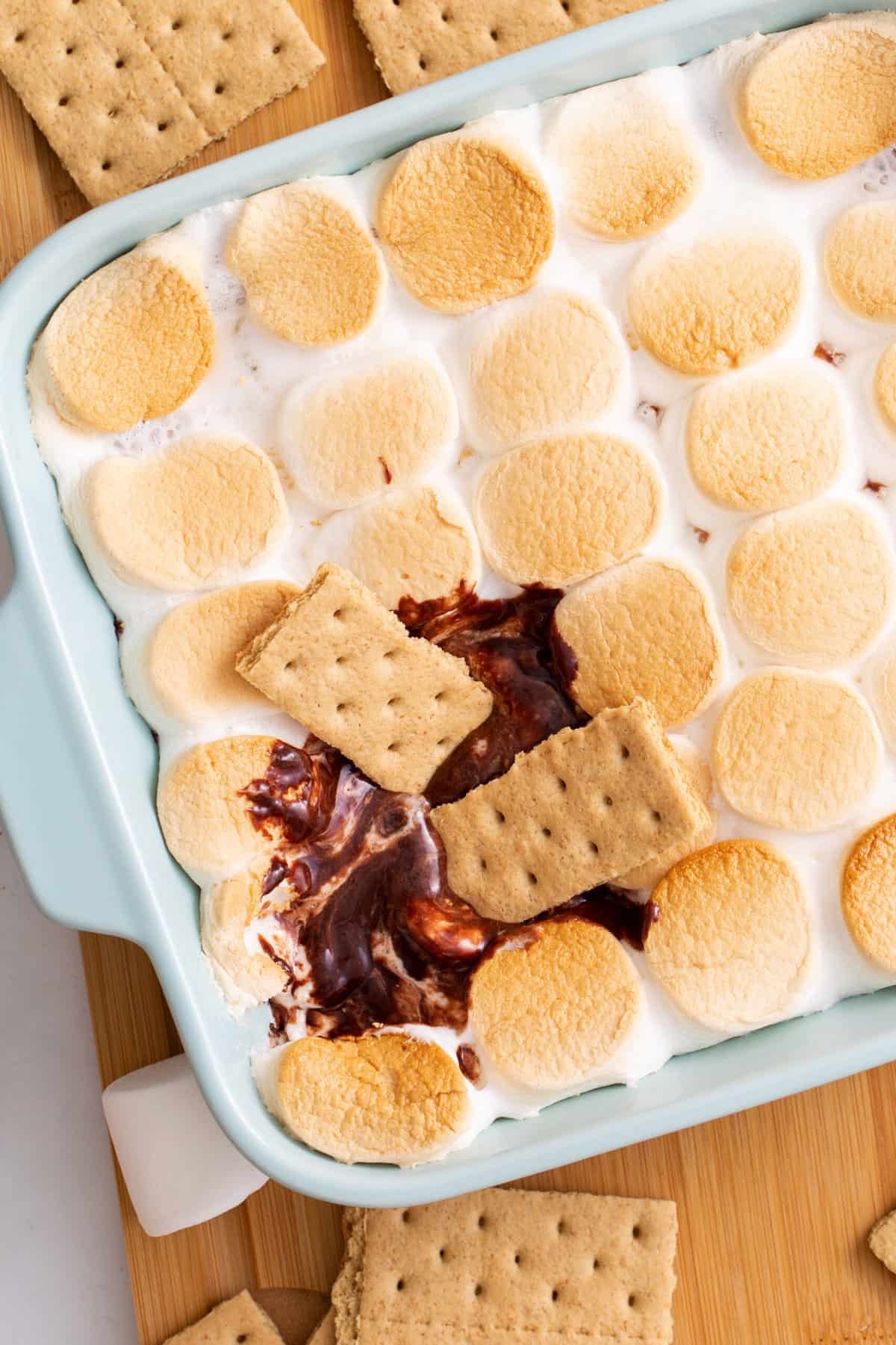 top down image of two graham crackers dipped into s'mores dip