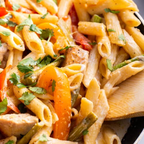 A skillet full of spicy chicken chipotle pasta.