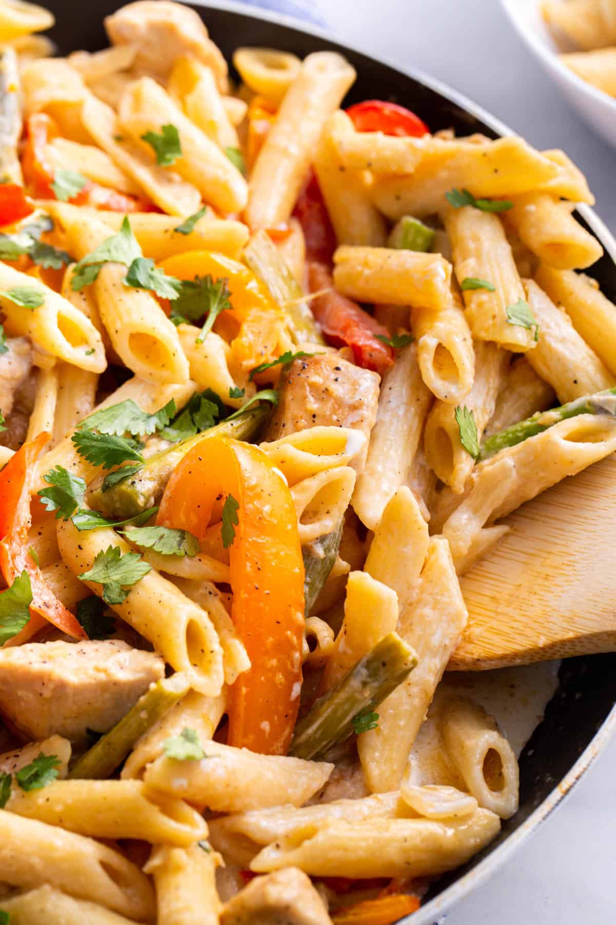 close up image of spicy chicken chipotle pasta served in a saute pan