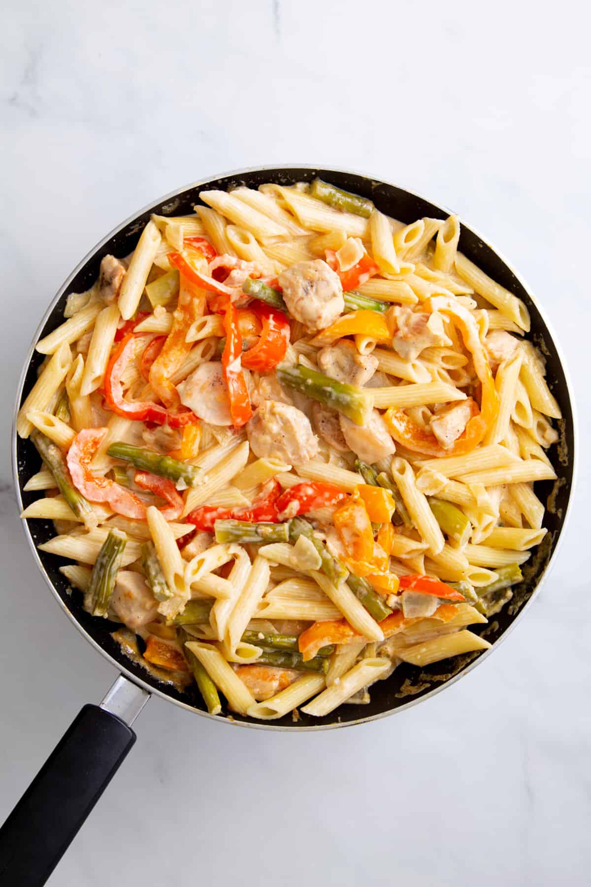 step 4 to make spicy chicken chipotle pasta, combine cooked pasta and chicken chipotle veggie mixture.