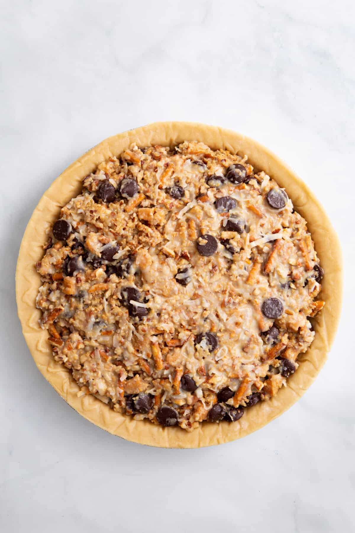 step 3 to make texas trash pie, prepare mixture into the store-bought par-baked pie crust pan.