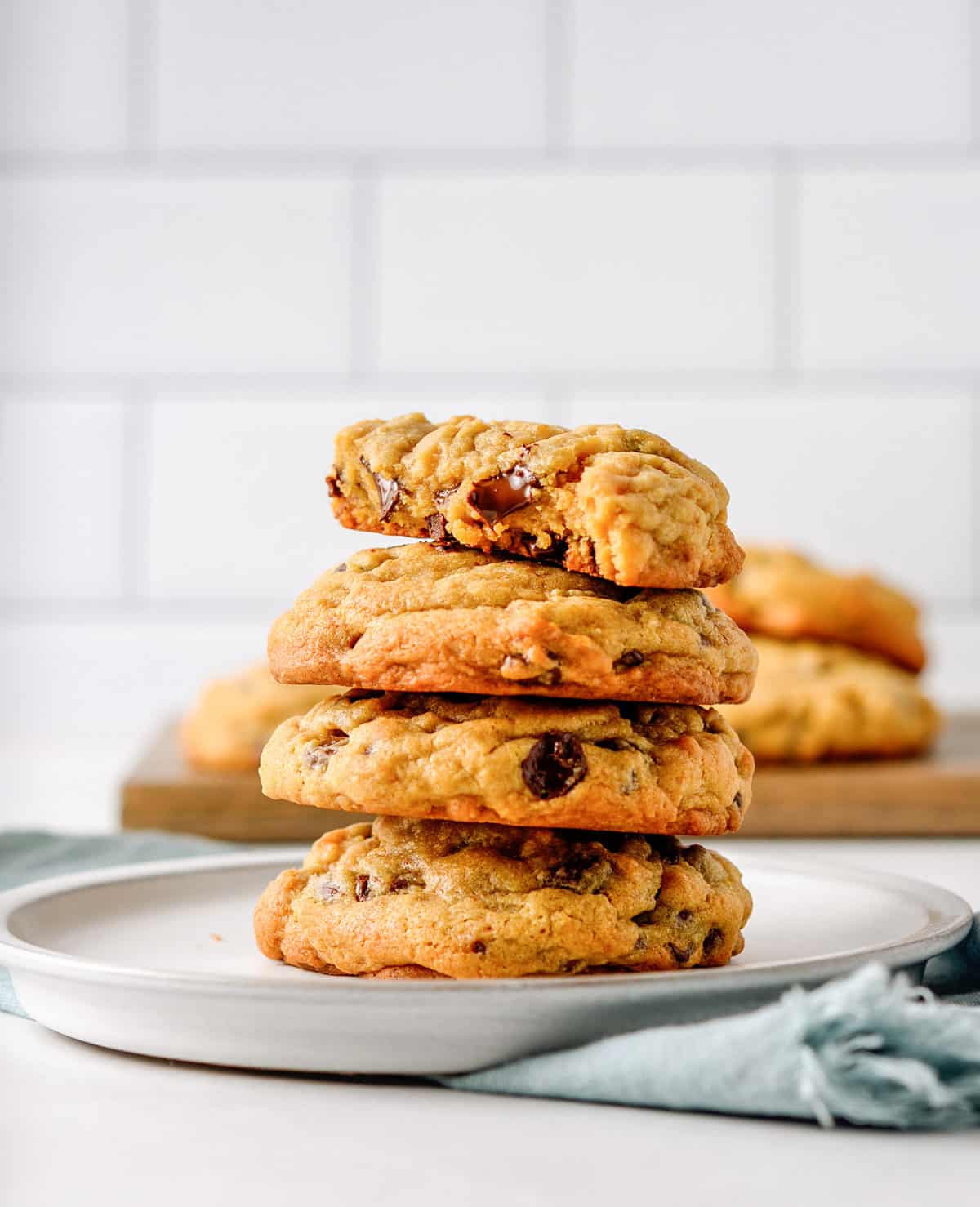 stack of four chocolate chip pudding cookies served on a grey round plate