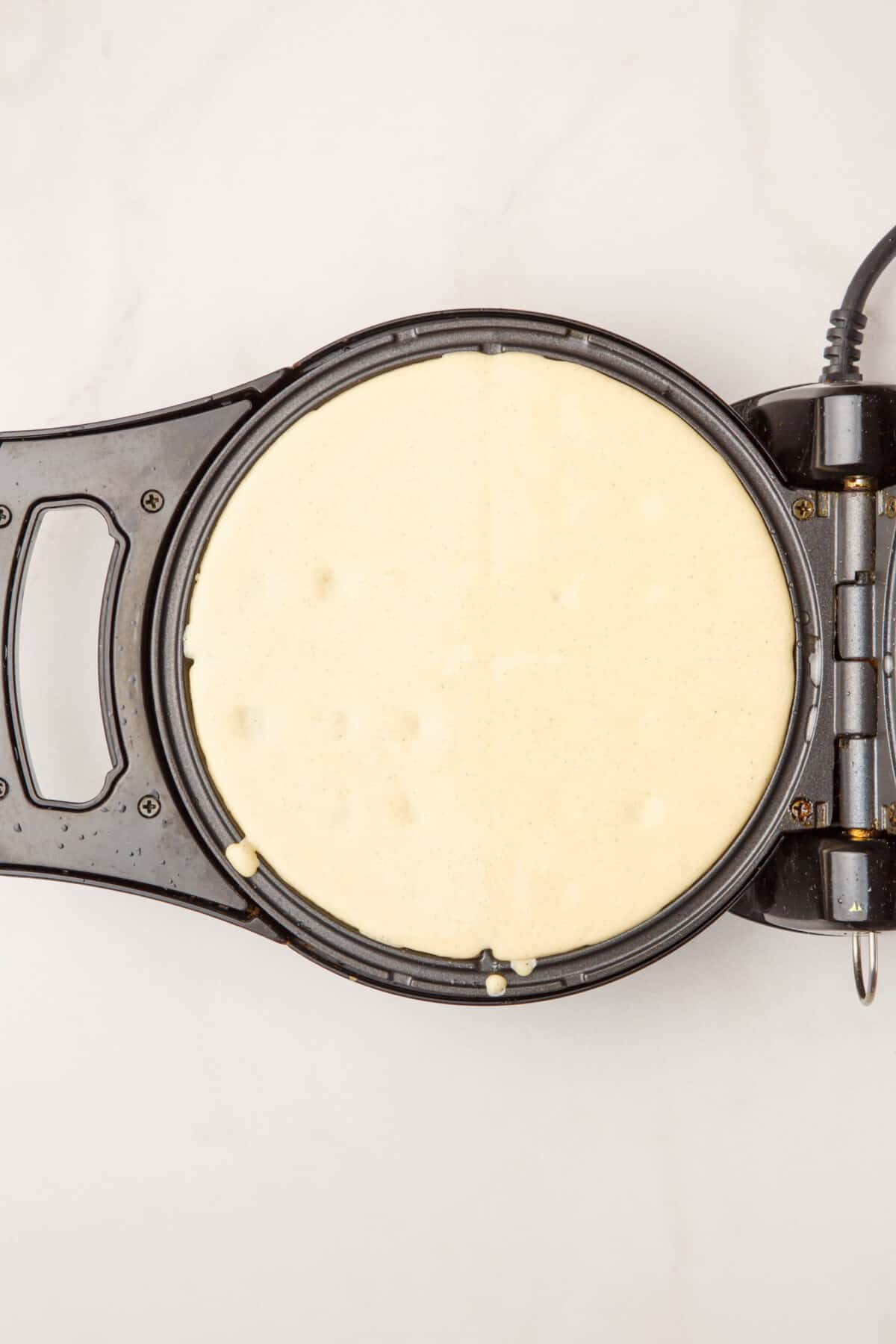 waffles batter on a waffle iron.