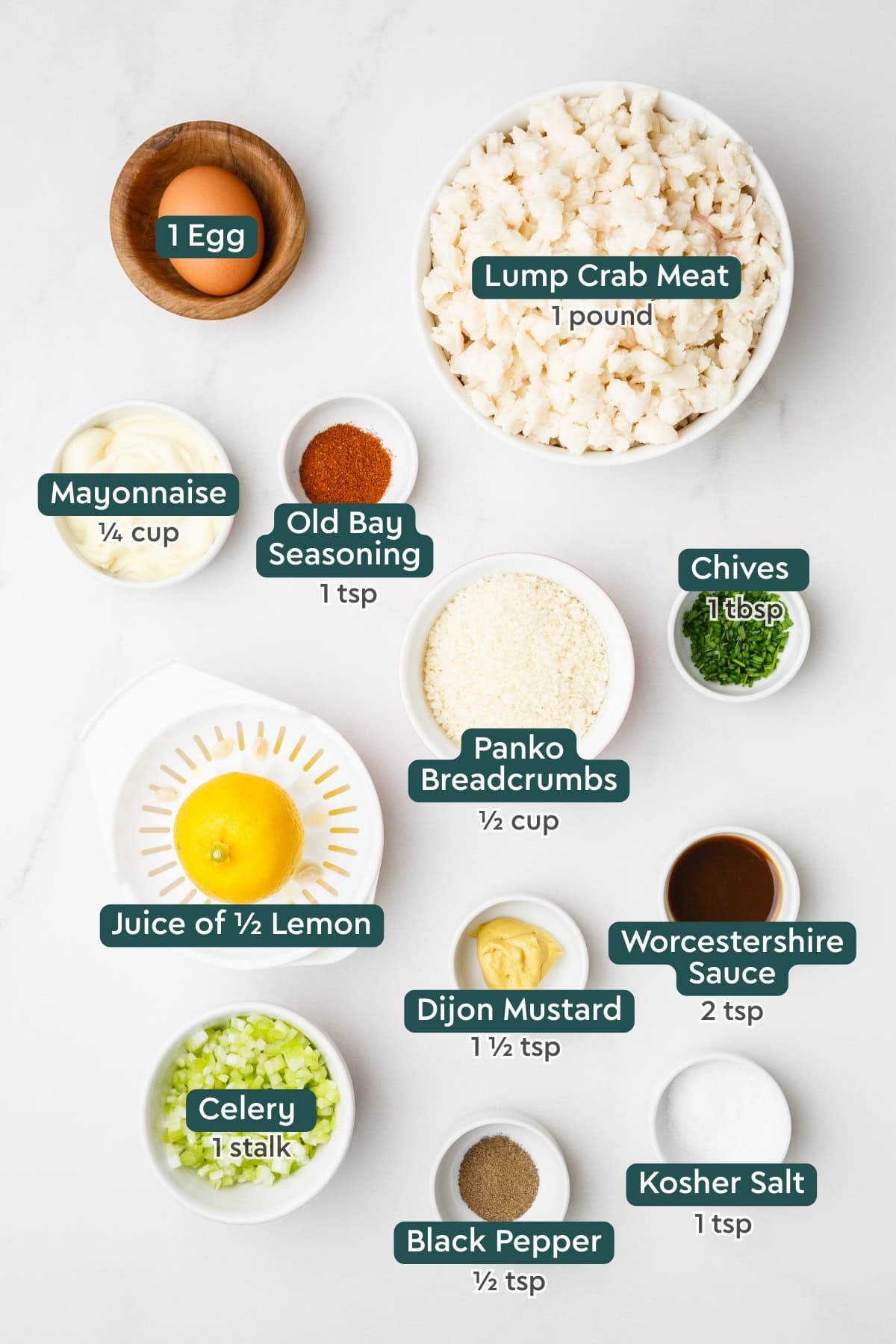 Ingredients for crab cake sandwich, including egg, crab, mayo, seasonings, panko, chives, lemon, dijon, worcestershire, celery.