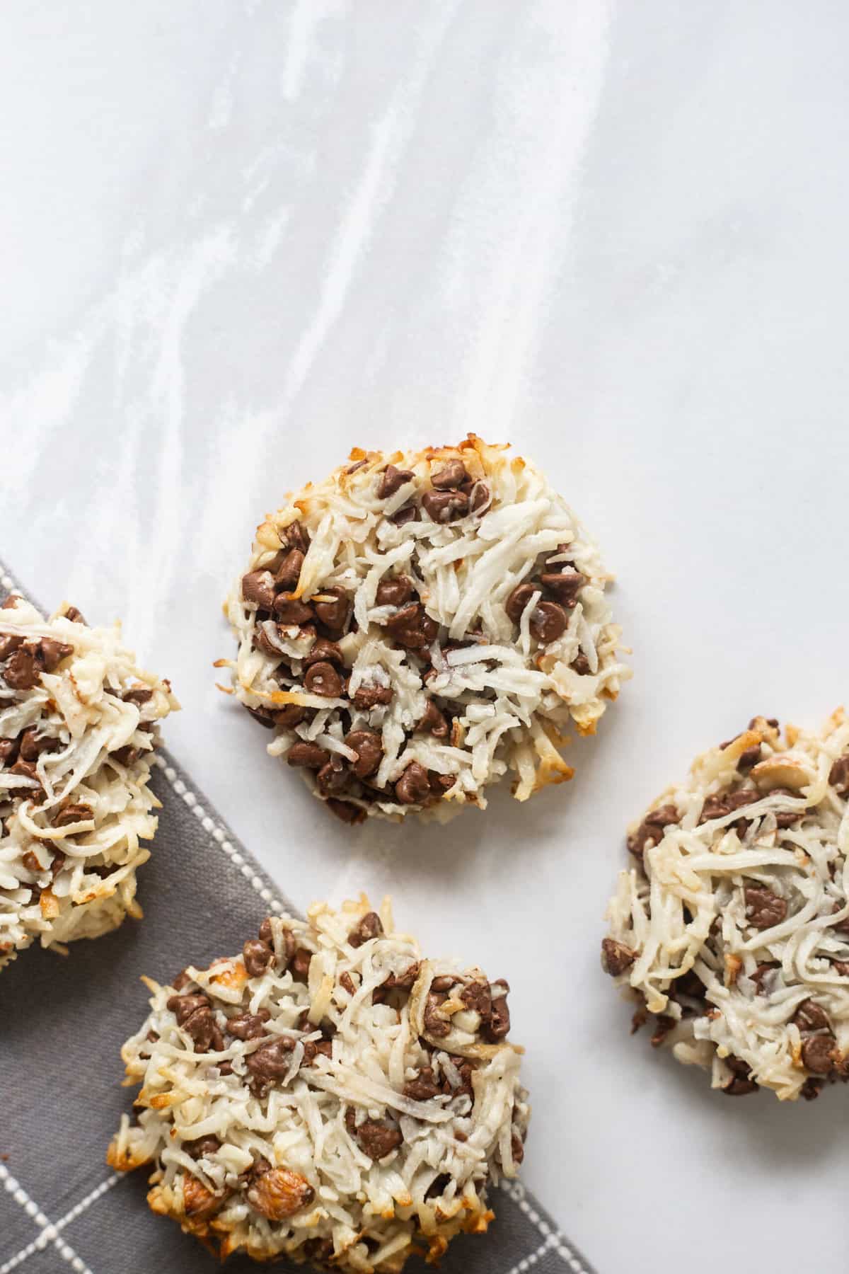 close up image of almond joy cookies sitting on a counter