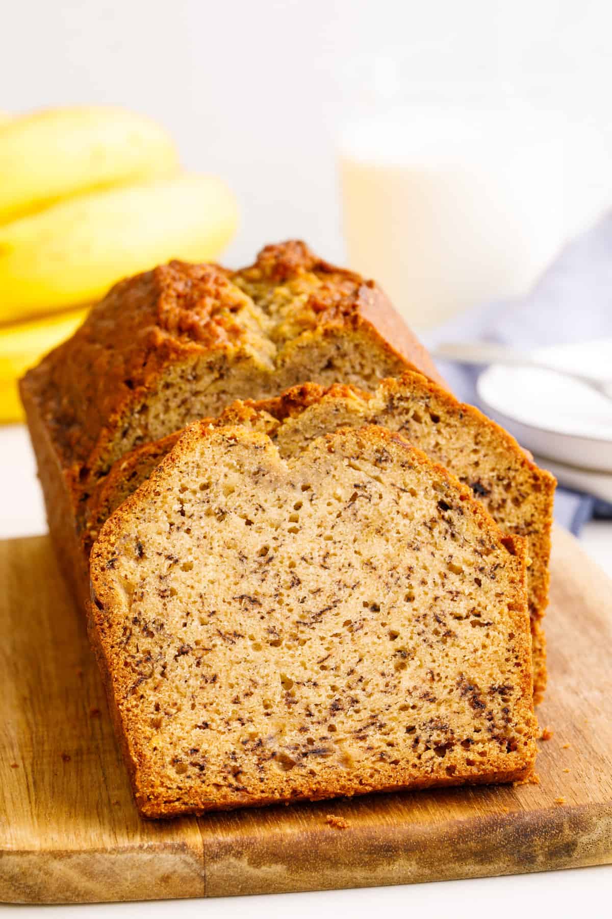close up image of one bowl banana bread sitting on a wood board