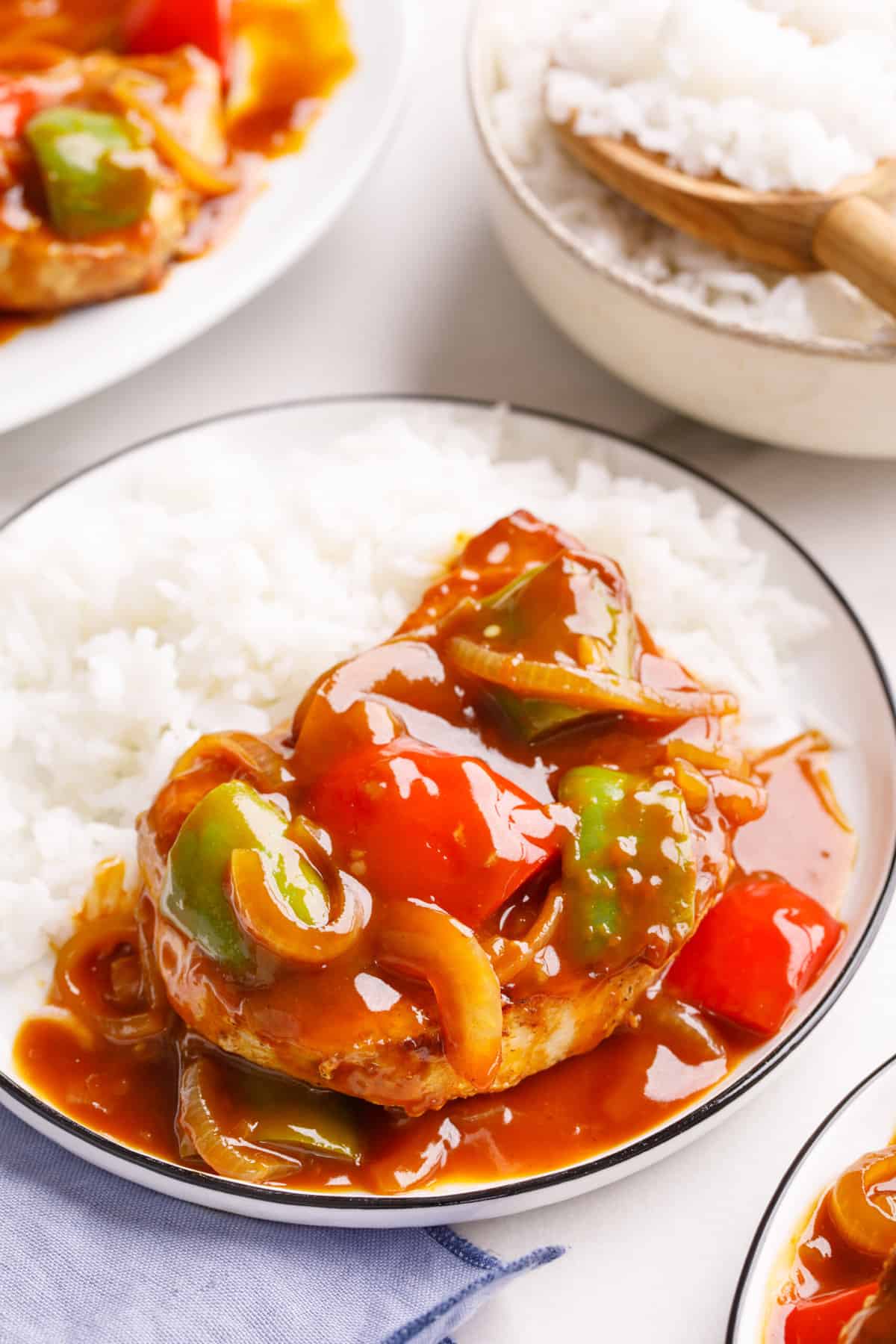 sweet and sour pork chops served on a plate with a side of white rice