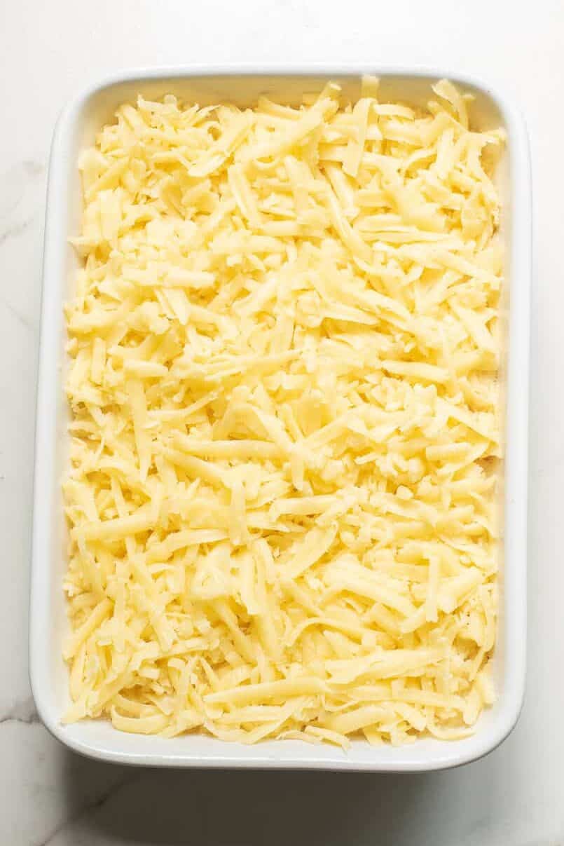 step 4 to make cheesy egg and potatoes casserole, top casserole with shredded cheese