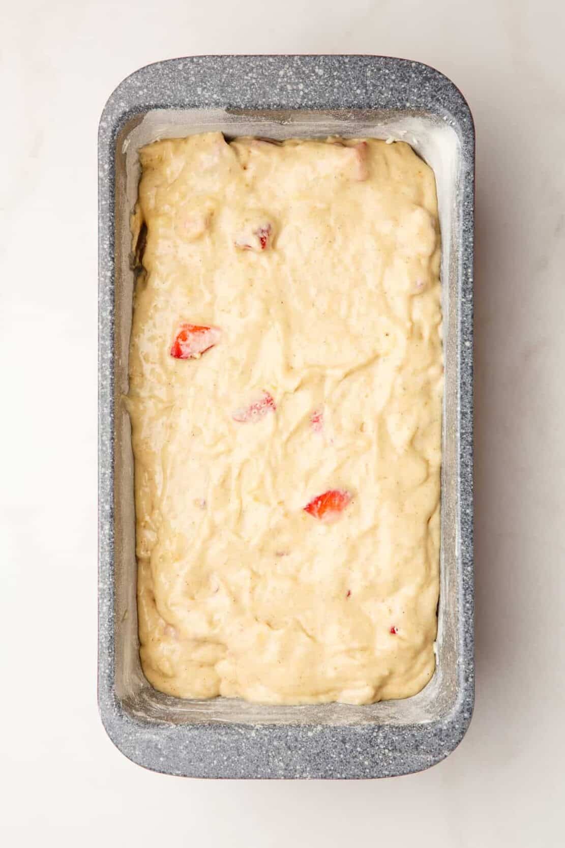 Step 4 to make strawberry banana bread, pour batter into a prepared 9x13-inch loaf pan.
