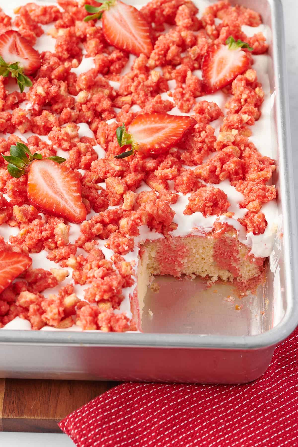 close up image of a 9x13 baking pan with strawberry crunch poke cake