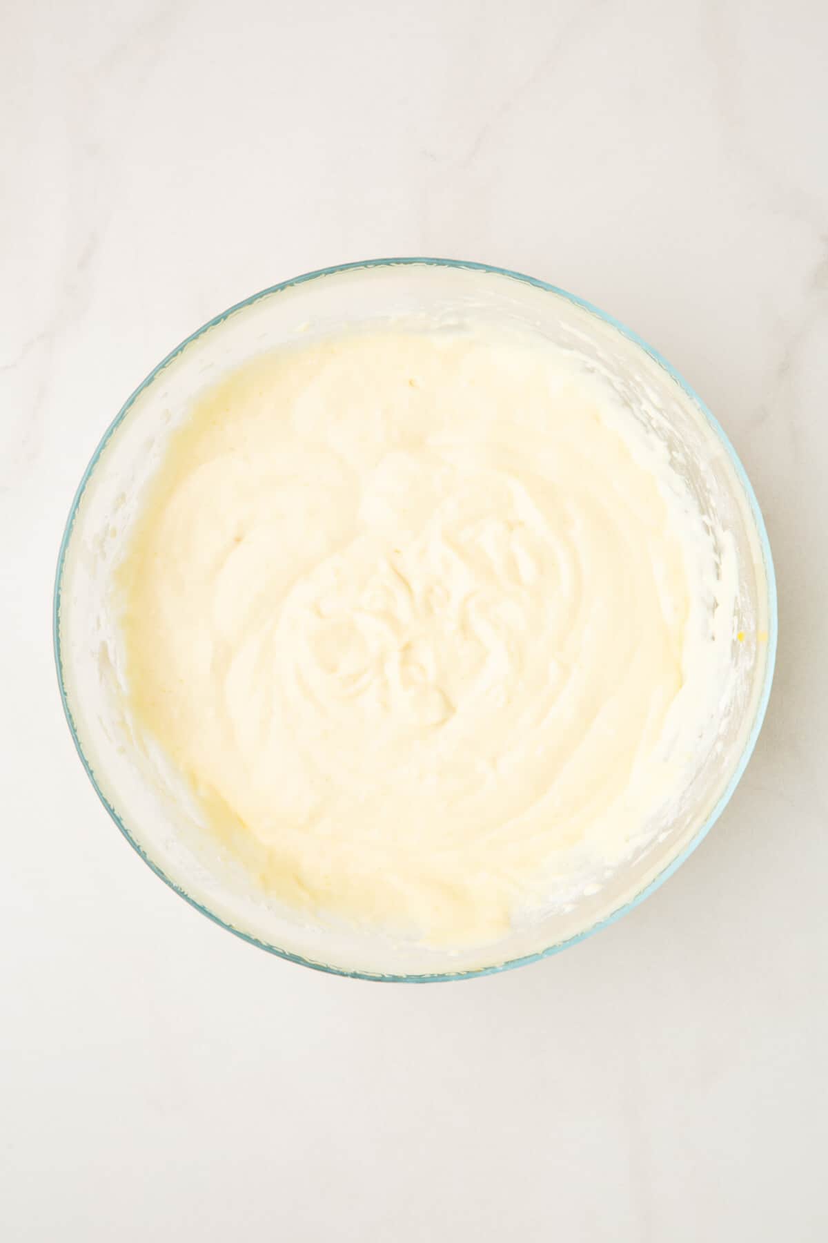 step 2 to make strawberry pancakes, wet pancake batter in a large glass bowl.