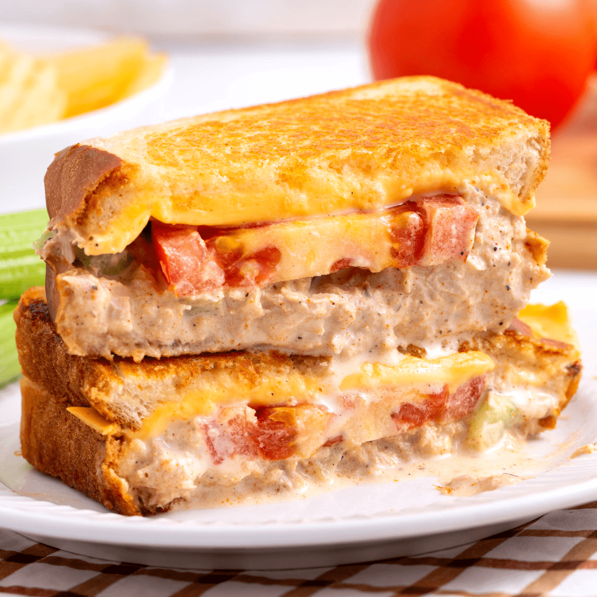 Two halves of a tuna melt sandwich stacked on top of each other.