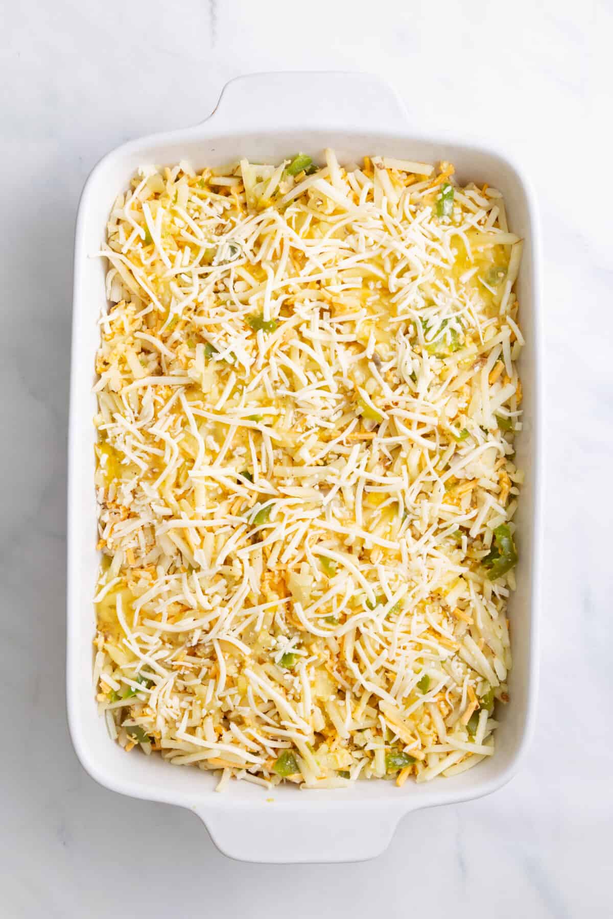step 4 to make cheesy breakfast potato casserole, top with more shredded cheese.