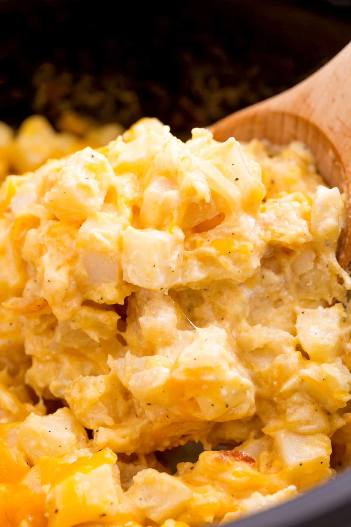 close up image of cheesy potatoes in a crockpot