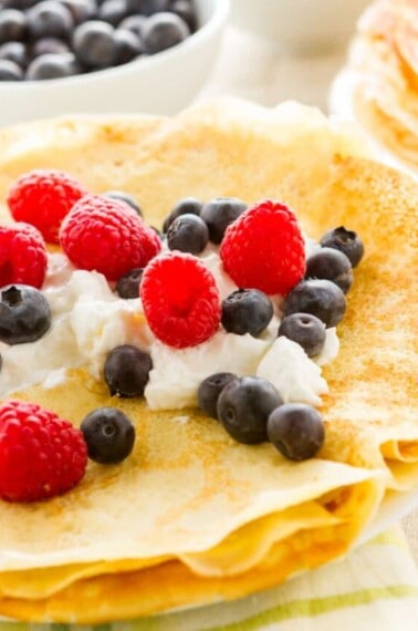 Homemade crepes with fresh raspberries and blueberries.