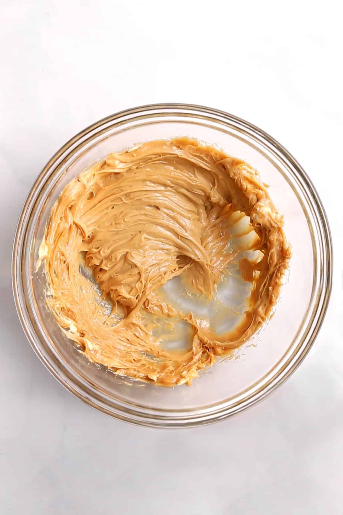 peanut butter and softened butter combined in a large glass bowl.