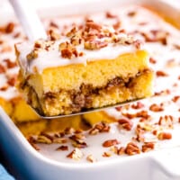 A slice of honey bun cake being lifted from a dish.