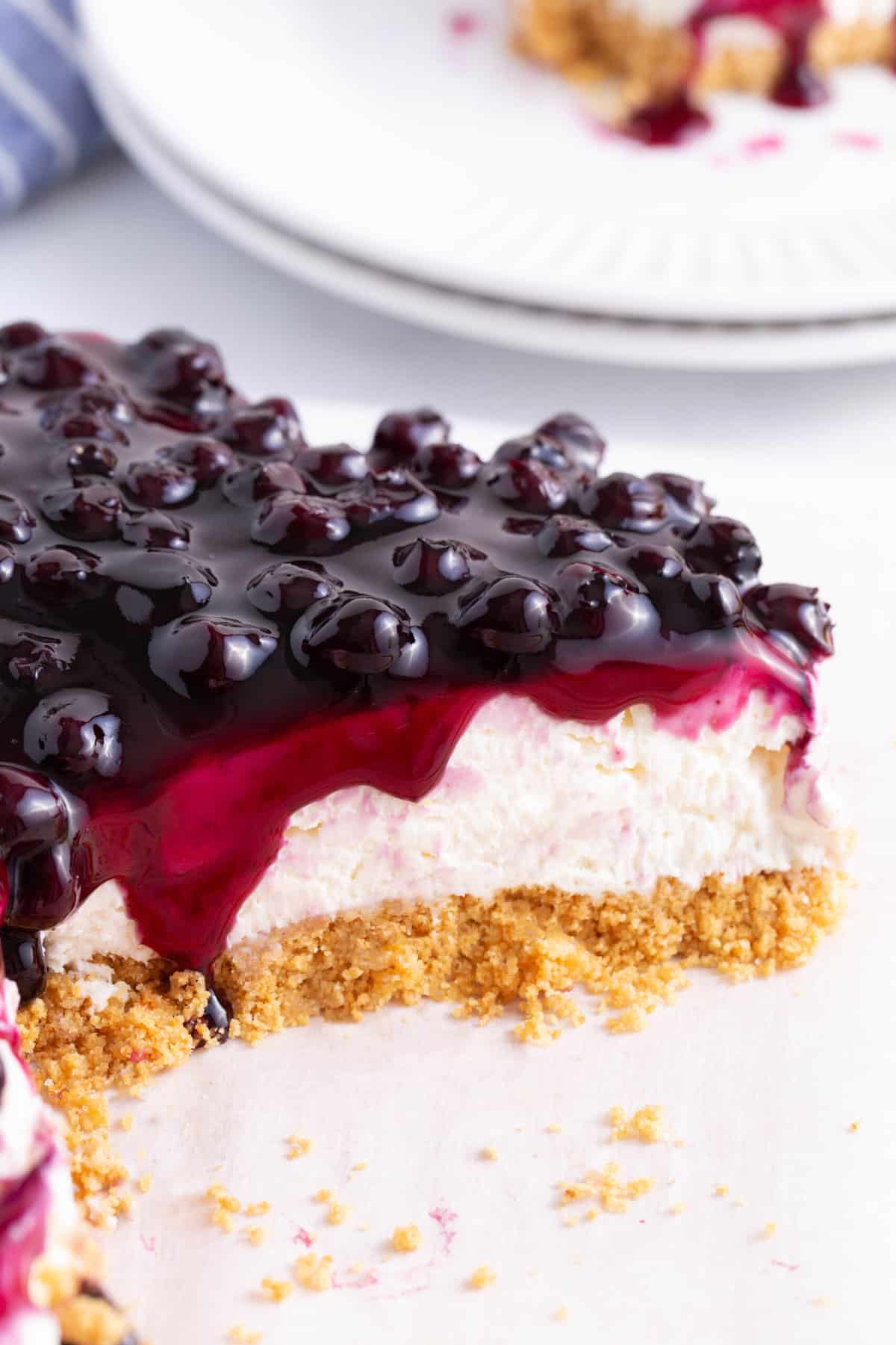 close up image of the cross section of a no-bake blueberry cheesecake