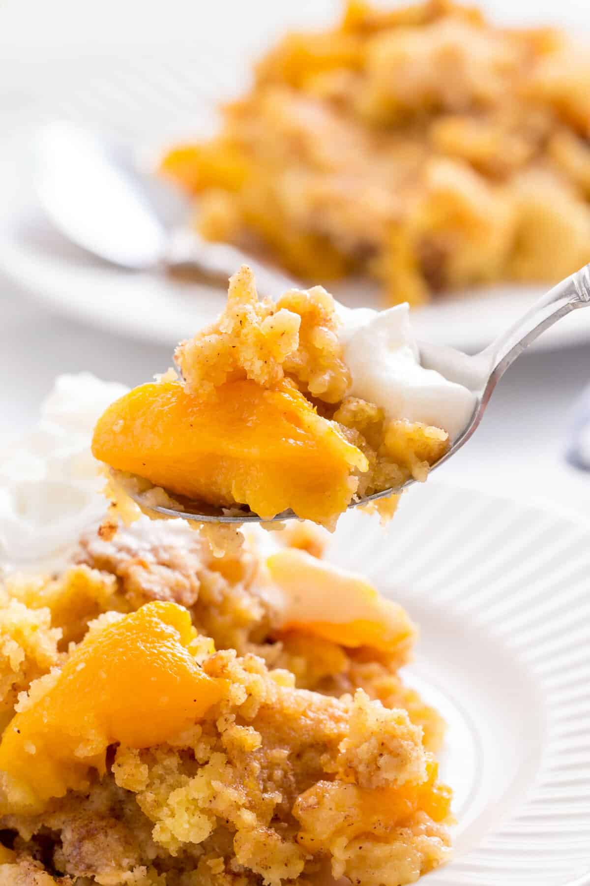 spoonful of peach cobbler made with cake mix