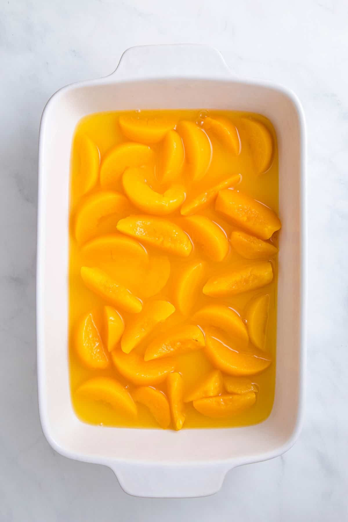 9 by 13 inch casserole dish with canned peaches